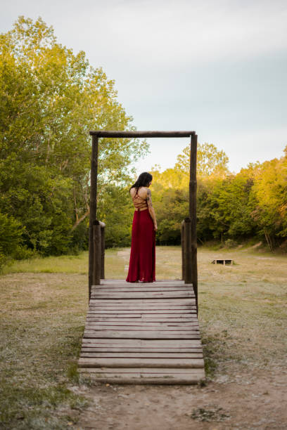 woman in red dress stepping through door woman in red dress stepping through door