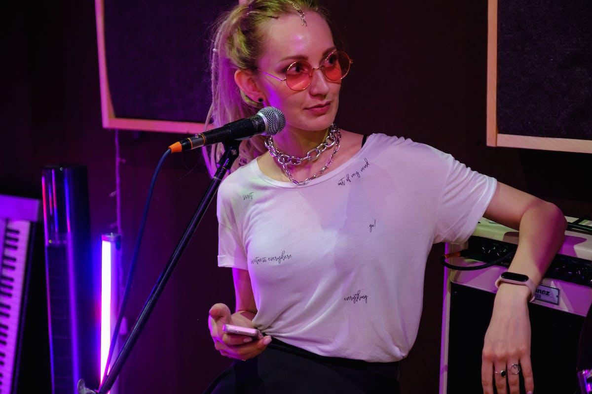 Woman singing into a microphone