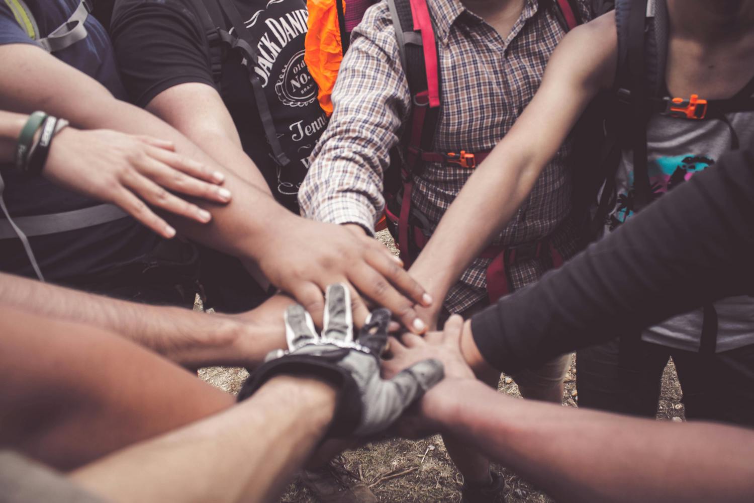 People putting their hands together supportively